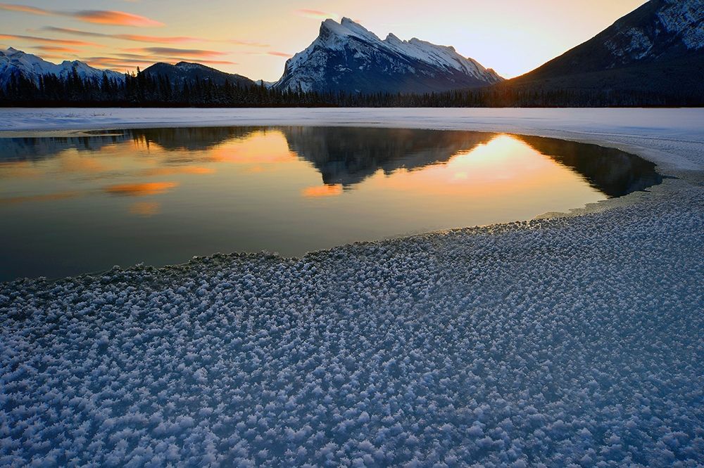 Snow crystals rim a lone break in the ice on Vermilion Lakes on a cold Banff National Park winter mo art print by Steve Mohlenkamp for $57.95 CAD